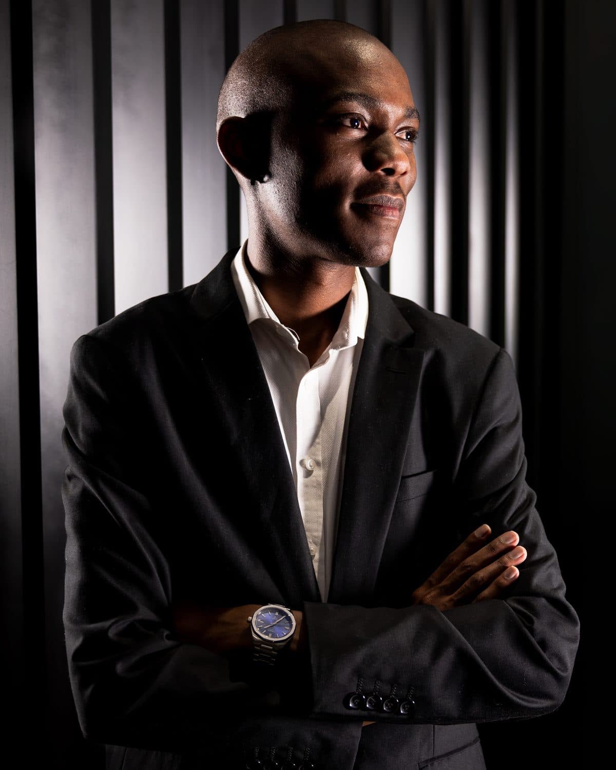 Vuyo Nkadimeng, arms folded, in a studio portrait